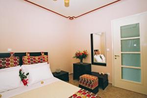 a bedroom with a large bed and a mirror at PIERIDES SUITES in Kardamyli