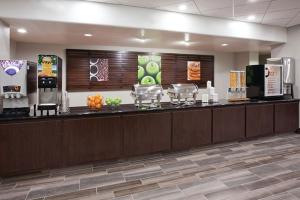 a lobby with a food counter in a hospital at La Quinta by Wyndham Clifton Park in Clifton Park