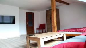 a bedroom with a bed and a table in a room at Apartmány Kukaččí hnízdo in Benešov nad Ploučnicí