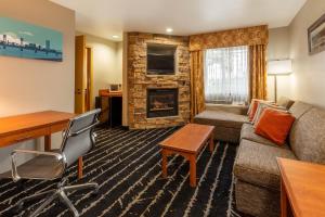 a living room with a couch and a fireplace at La Quinta by Wyndham Vancouver in Vancouver
