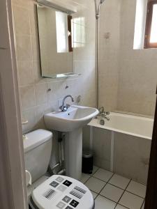 a bathroom with a sink and a toilet and a tub at La Condaminoise in Condamine-Châtelard