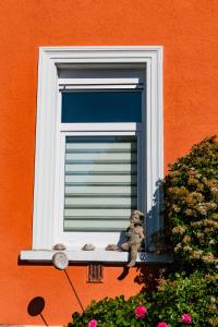 a stuffed teddy bear sitting on a window sill at Appartement 24 in Lindau