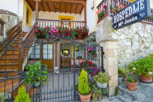 an entrance to a building with flowers and plants at Hospedaje Maria Jesus in Santillana del Mar