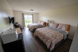 a hotel room with two beds and a couch at Pacific City Inn in Pacific City