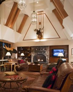 a large living room with a stone fireplace at North Conway Grand Hotel in North Conway