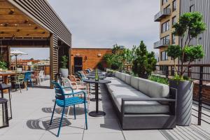 a patio with tables and chairs on a building at Crossroads Hotel in Kansas City