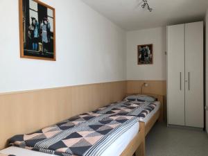 a bedroom with a bed with a picture on the wall at Fewo Belinda, Tiengen Zentrum in Waldshut-Tiengen