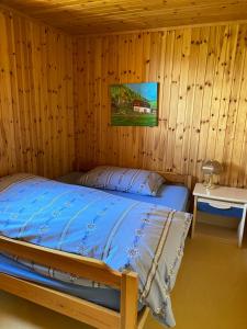 a bedroom with a bed in a wooden cabin at FeWo Oberhischru in Eischoll