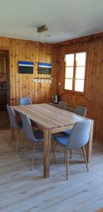 una sala da pranzo con tavolo e sedie in legno di Chalet Orion a Bellwald