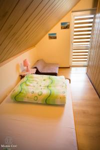 a bedroom with a bed with a green comforter at Domki u Strażaka obiekt Całoroczny in Solina