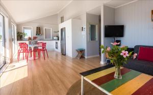 a living room with a couch and a table at THE WAIHEKE PAD - in the heart of Oneroa! - Be My Guest Waiheke in Oneroa