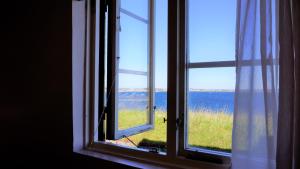 an open window with a view of the ocean at Fästningens in Varberg