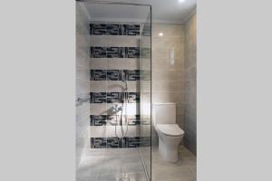 a bathroom with a toilet and a glass shower at Beach Luxury Suite in Tsilivi +13 photos