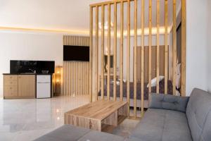 a living room with a couch and a table at Beach Luxury Suite in Tsilivi