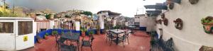 a patio with tables and chairs in a courtyard at Casa Azul in Guanajuato