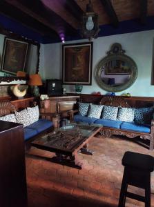 a living room with blue couches and a table at Casa Azul in Guanajuato