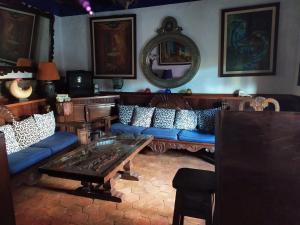 a living room with blue couches and a table at Casa Azul in Guanajuato