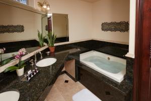 a bathroom with two sinks and a bath tub at South Coast Winery Resort & Spa in Temecula