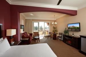 a hotel room with a bed and a living room at South Coast Winery Resort & Spa in Temecula