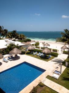 a view of a resort with a swimming pool and the beach at Casa Frida in Puerto Morelos