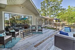 a deck with chairs and tables on a house at Luxury Hot Springs Oasis on Lake with Private Dock! in Hot Springs