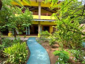 a walkway in front of a yellow building at Villas Verdes in Sámara