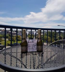 two bottles of champagne sitting on a table on a balcony at Panorama Motor Lodge in Timaru