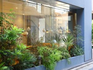a store window with a bunch of plants at KOKO HOTEL Ikebukuro East in Tokyo