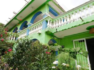 a colorful house with blue and white trim at Iguana Hostel in San Cristóbal de Las Casas