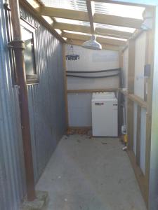 a garage with a washer and dryer in it at Clifden Pitstop in Eastern Bush