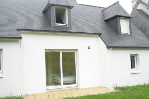 a white house with a gray roof at Beg Meil in Fouesnant