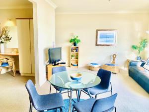 a living room filled with furniture and a tv at The Bluff Resort Apartments in Victor Harbor