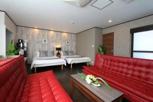 大阪市にあるLiz5 Guest House Liz Nakazakichoの赤い家具と赤いソファ付きのリビングルーム