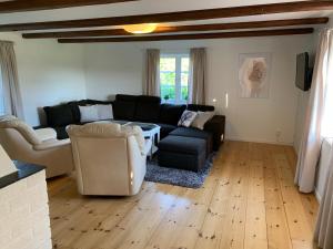 a living room with a couch and chairs at Rinkeby Gård in Jönåker