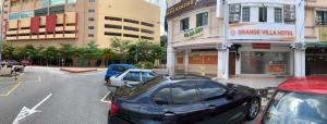 a group of cars parked in a parking lot at Orange Villa Hotel Near Palm Mall Seremban in Seremban