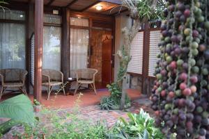 a house with a patio with a bunch of plants at Sala Prabang Hotel in Luang Prabang