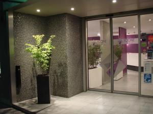 a vase with a plant in front of a store at Icône Hôtel - Annecy in Annecy