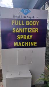 a sign for a full body sanitizer spray machine at Hotel Blue Sapphire in Dar es Salaam