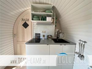 a kitchen with an arched door and a counter top at Iglu Camp Triolago in Riol