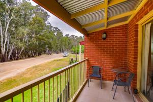 a patio area with a bench and a walkway at Murray Waters Motor Inn & Apartments in Koondrook