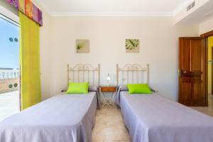 two beds sitting next to each other in a room at Villa Trebol in Mijas +32 photos