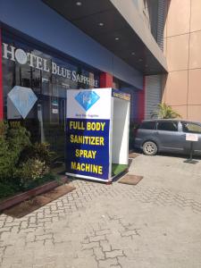 a sign in front of a hotel building at Hotel Blue Sapphire in Dar es Salaam