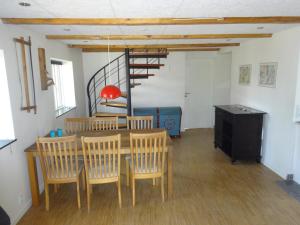 a dining room with a table and chairs and a staircase at Elmealle 6 in Skjern