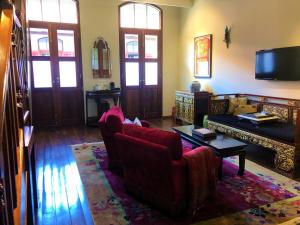 
a living room filled with furniture and a large window at Seven Terraces in George Town
