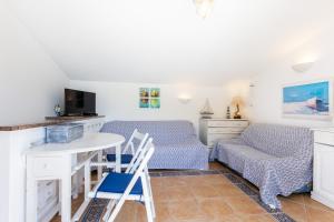 a room with two beds and a table and chairs at Casa Pedro Burgau in Burgau +17 photos