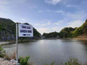 a sign that reads train guard canadian house next to a river at Tran Chau Garden Home in Cat Ba