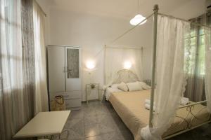 a bedroom with a bed with a canopy at Vithos in Agnontas