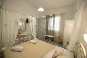 a bedroom with a bed and a sink and a mirror at Vithos in Agnontas