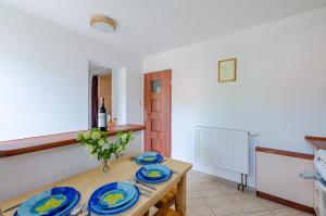 una cocina con una mesa con placas azules. en Ambelia en Stegna