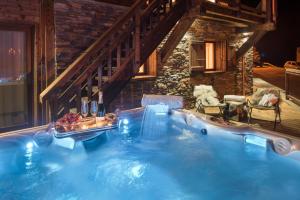 a hot tub with a waterfall in a house at Chalet Opale in Tignes